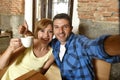 Couple taking selfie photo with mobile phone at coffee shop smiling happy in romance love concept Royalty Free Stock Photo