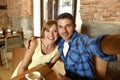 Couple taking selfie photo with mobile phone at coffee shop smiling happy in romance love concept Royalty Free Stock Photo