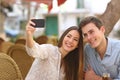 Couple taking a selfie photo in a restaurant