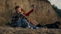 Couple taking selfie photo at sunset beach on smartphone. Happy lovers with dog Royalty Free Stock Photo