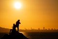 Couple taking social photos at sunset over city skyline