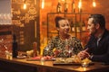 Couple talking behind bar counter in a cafe