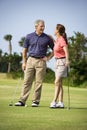 Couple talking on golf course Royalty Free Stock Photo