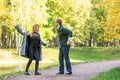 Couple talking seriously outdoors in a park with a green background Royalty Free Stock Photo