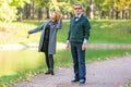 Couple talking seriously outdoors in a park with a green background Royalty Free Stock Photo