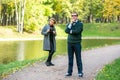 Couple talking seriously outdoors in a park with a green background Royalty Free Stock Photo