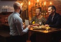 Couple talking to bartender behind bar counter in a cafe