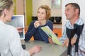 Couple talking to secretary at medical reception desk