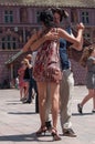 Couple of tango dancers on main place with other dancers at the spring tango festival