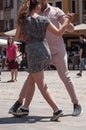 Couple of tango dancers on main place with other dancers at the spring tango festival