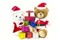 Couple teddy bear doll wearing santa set with many colorful gift boxes isolated on white background,Christmas day and New Year`s Royalty Free Stock Photo