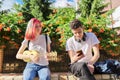 Couple of teenage hipsters outdoor, girl playing ukulele Royalty Free Stock Photo