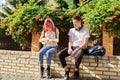 Couple of teenage hipsters outdoor, girl playing ukulele Royalty Free Stock Photo