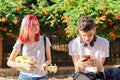 Couple of teenage hipsters outdoor, girl playing ukulele Royalty Free Stock Photo