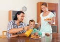 Couple with teenager son having breakfast in home