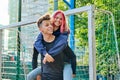 Couple of teenagers guy and girl having fun on an outdoor basketball court Royalty Free Stock Photo