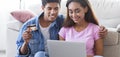 Couple Of Teenagers Making Online Purchases On Laptop At Home Royalty Free Stock Photo