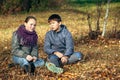 A couple of teenagers meet romantically outdoors.