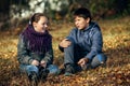 A couple of teenagers meet romantically in the Park.