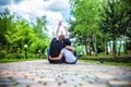 Couple of teenagers sit in street together Royalty Free Stock Photo