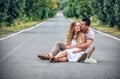 Couple of teenagers sit in street together Royalty Free Stock Photo