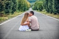 Couple of teenagers sit in street together Royalty Free Stock Photo