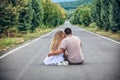 Couple of teenagers sit in street together Royalty Free Stock Photo