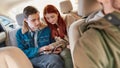 A couple of teenagers using their smartphones while sitting on back seat in the car Royalty Free Stock Photo