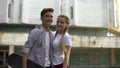 Couple of teens with skateboard looking at camera and smiling, youth subculture