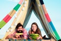 Couple in a tent. Camping lovers. Romantic couple eating watermelon and corn. Royalty Free Stock Photo