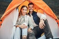 Couple, tent and camping in portrait, smile and happy for holiday, nature and morning in countryside. Man, woman and