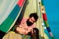 Couple in a tent. Sensual portrait of young couple in love camping. Loving couple embracing and kissing. Royalty Free Stock Photo