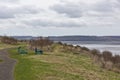 A Couple and their Dog taking a rest at one of the Picnic Tables in the Riverside Nature Trail  overlooking the Tay Estuary. Royalty Free Stock Photo