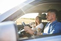 Young couple and their dog traveling by car in summertime Royalty Free Stock Photo