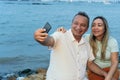 Couple in their fifties taking a selfie with their cell phone Royalty Free Stock Photo