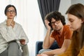 Couple in a therapy session. The man looking at his girlfriend with deep sadness and regret Royalty Free Stock Photo