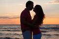 Couple about to kiss at beach during sunset Royalty Free Stock Photo