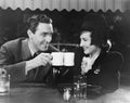 Couple toasting with mugs Royalty Free Stock Photo