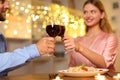 Couple toasting over dinner with a romantic light backdrop Royalty Free Stock Photo