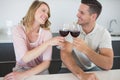 Couple toasting red wine glasses at table Royalty Free Stock Photo