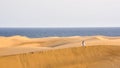 Couple together in desert with ocean in the background