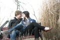 Couple Touching Noses On Park Bench Royalty Free Stock Photo