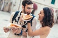 Couple of tourist eating pizza on street Royalty Free Stock Photo