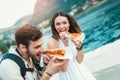 Couple of tourist eating pizza on street near the sea Royalty Free Stock Photo