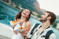 Couple of tourist eating pizza on street near the sea Royalty Free Stock Photo