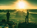 Couple tourist with photo camera at top of mountain watch sunset