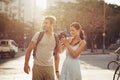 Couple, tourist and photography in street for travel, sightseeing and happiness on holiday or vacation in Brazil. Camera Royalty Free Stock Photo