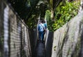 Couple of tourist walking through suspension old bridge in the middle of rainforest Royalty Free Stock Photo