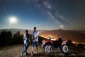 Couple tourists with atv quad bike under night starry sky Royalty Free Stock Photo