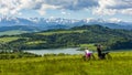 A couple of tourists came by bicycles to the viewpoint. The man is looking through the binoculars. A woman sends a photo taken by